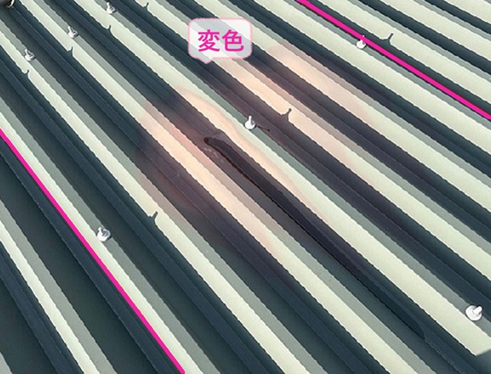 火災被害を受けた集合住宅の2枚の折板屋根が焦げて変色している様子