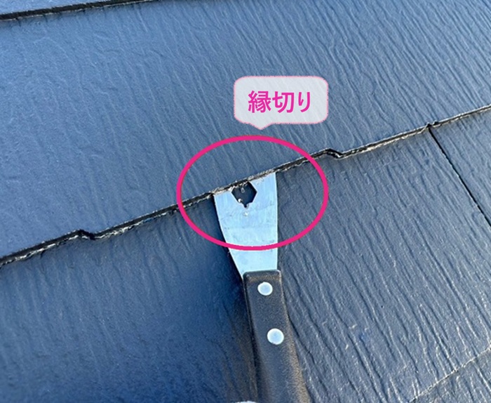 平型スレート屋根の塗り替えで縁切り作業をしている様子