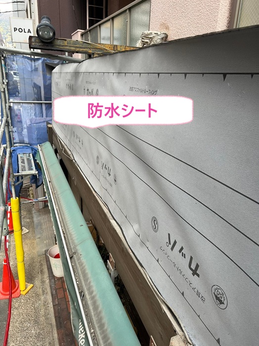 神戸市中央区の店舗の屋根改修工事で防水シートを貼っている様子