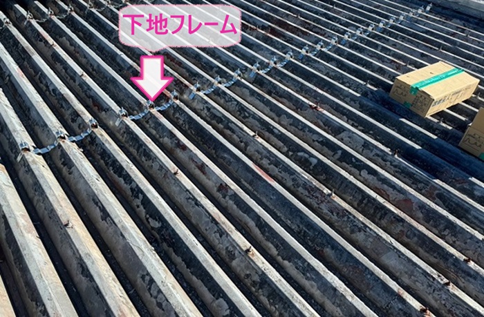 折板屋根の改修工事で下地フレームを取り付けている様子