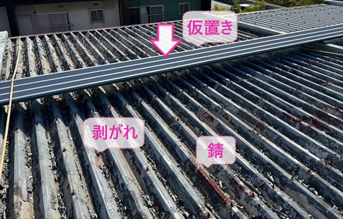 折板屋根の改修工事で錆や剥がれが酷い既存の折板屋根の上に新しい屋根材を仮置きしている様子