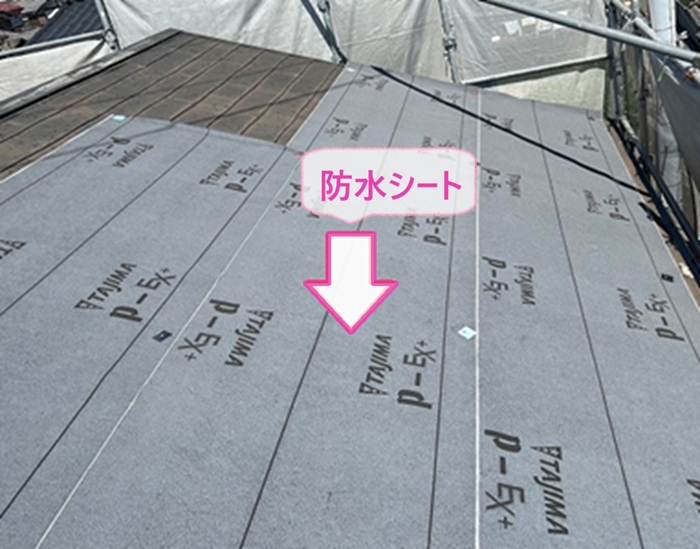 切妻スレート屋根の改修で防水シートを貼っている様子