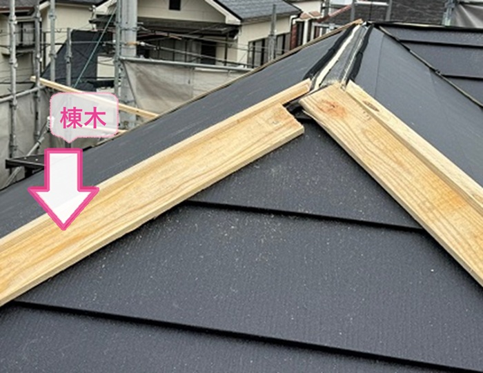 カラーベスト屋根の重ね葺きで棟木を取り付けている様子