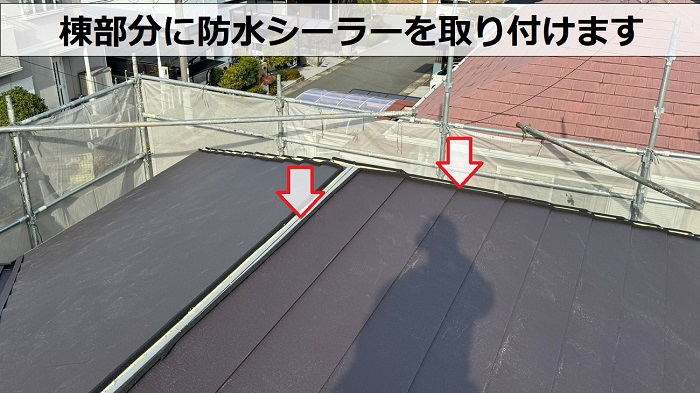 ＳＧＬ鋼板屋根材の棟部分に防水シーラーを取り付けている様子