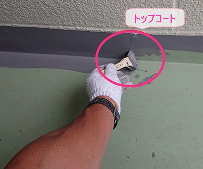 ベランダ防水工事でトップコートを塗っている様子