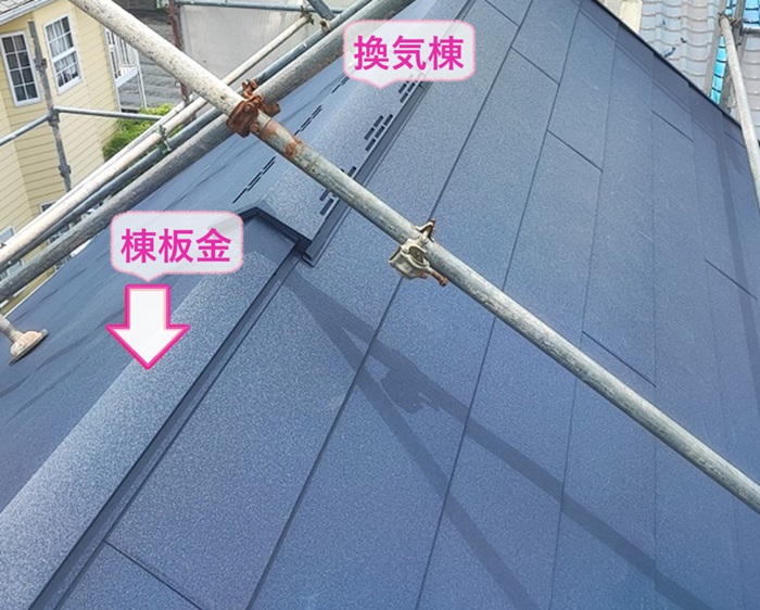 切妻屋根の改修工事で棟板金と換気棟を取り付けている様子