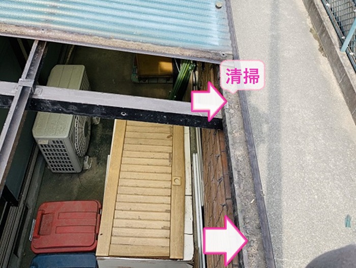 ストックヤードの波板交換で雨樋内部を掃除している様子