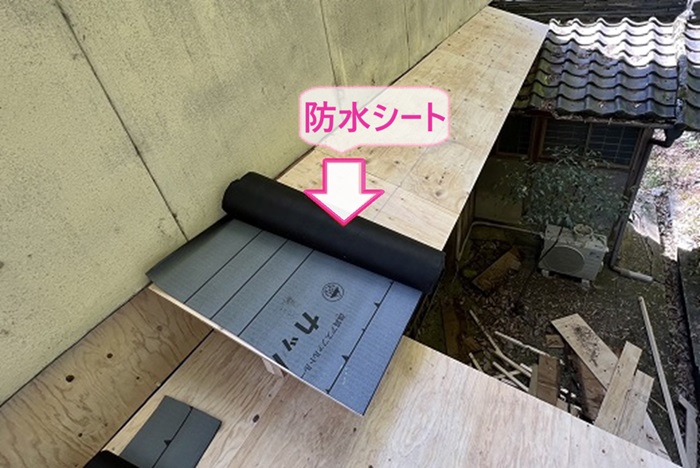 窓上の小庇の板金補修で新しい防水シートを貼っている様子