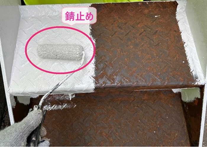 鉄骨製の外階段の塗り替えで錆止めを塗っている様子