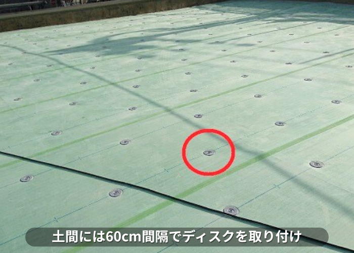 南あわじ市　ンション屋上防水工事の塩ビシート機械固定工法でディスクを取り付けている様子