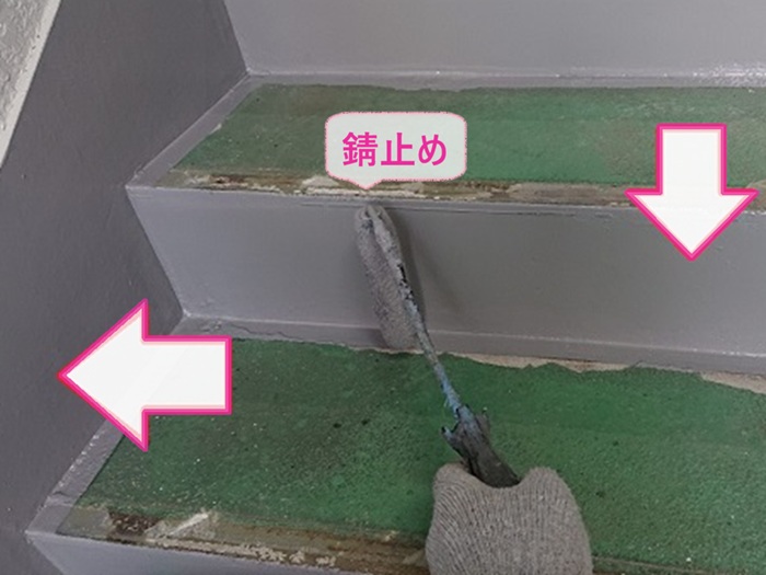アパート共用部の床改修で鉄部に錆止めを塗っている様子